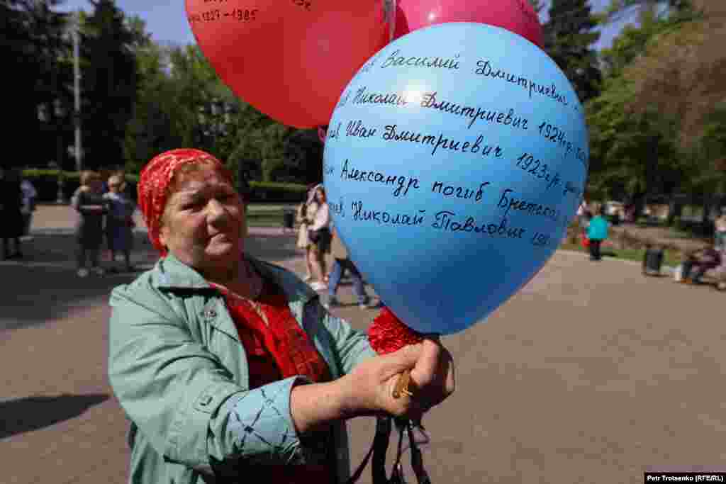 Екінші дүниежүзілік соғыста қаза болған жақындарының есімін шарға жазып алған әйел.&nbsp;