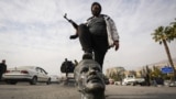 SYRIA – An opposition fighter steps on a broken bust of the late Syrian President Hafez Assad in Damascus, Syria, Dec. 8, 2024