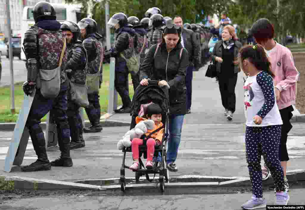 Арнайы жасақ маңынан өтіп бара жатқан тұрғындар. Нұр-Сұлтан, 10 маусым 2019 жыл.