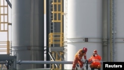 Kazakhstan -- Employees work at a drill rig at an offshore island in the northern Caspian Sea, part of the Kashagan oilfield, 11Oct2012